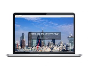 website design view on macbook London skyline with cranes home page for Dewey Group creative work website design and marketing
