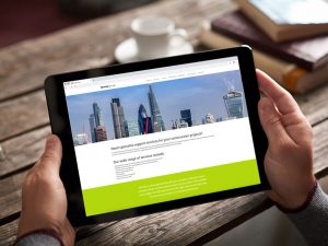 website design view on ipad London skyline with cranes home page for Dewey Group creative work website design and marketing