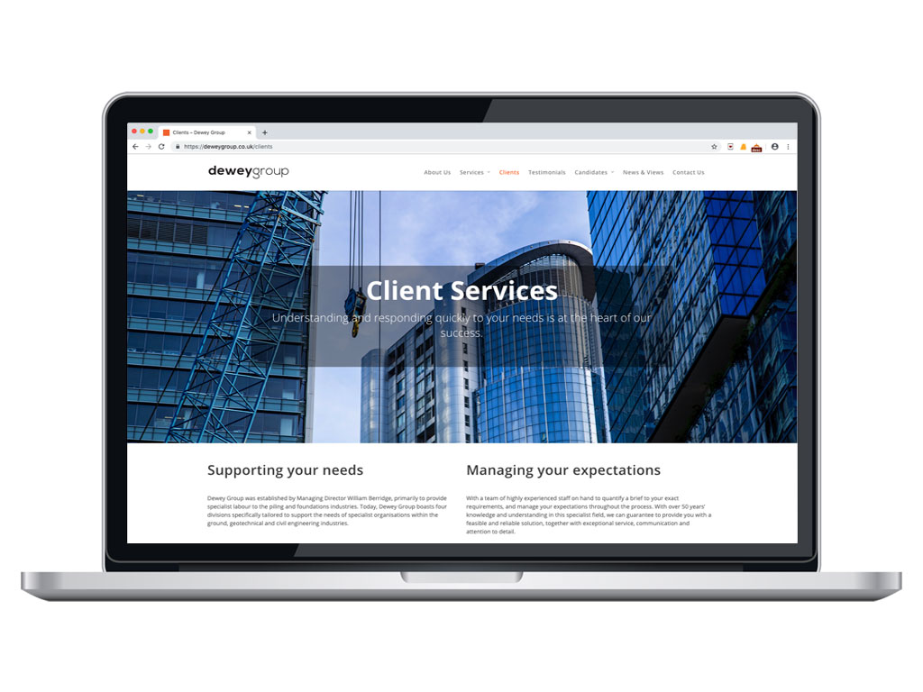 website design view on macbook glass buildings client services page for Dewey Group creative work website design and marketing