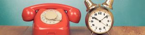 retro dial red telephone and retro brass alarm clock