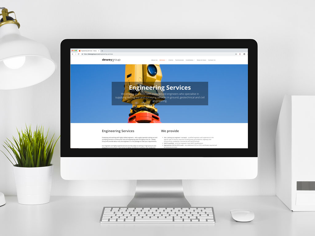 website design view on imac theodolite surveying and engineering services page for Dewey Group creative work website design and marketing