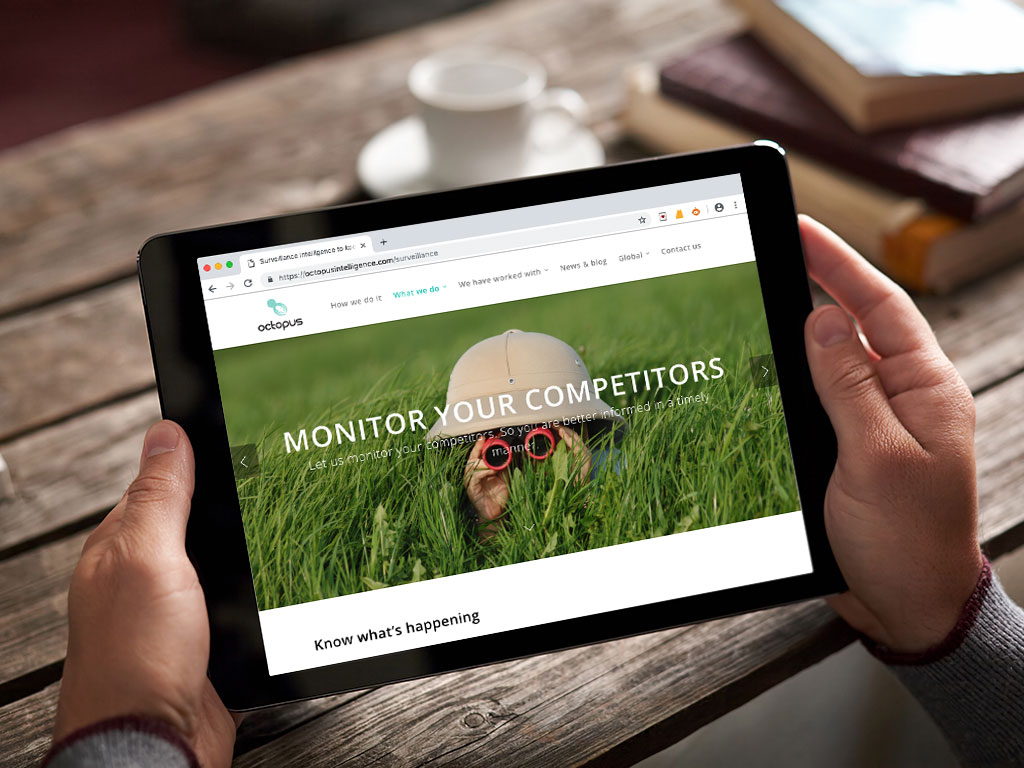 website design view on ipad binocculars intelligence monitoring page for Octopus intelligence creative work website design and marketing